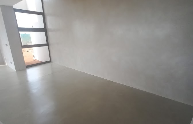 Light grey micro screed floor and feature wall in modern home