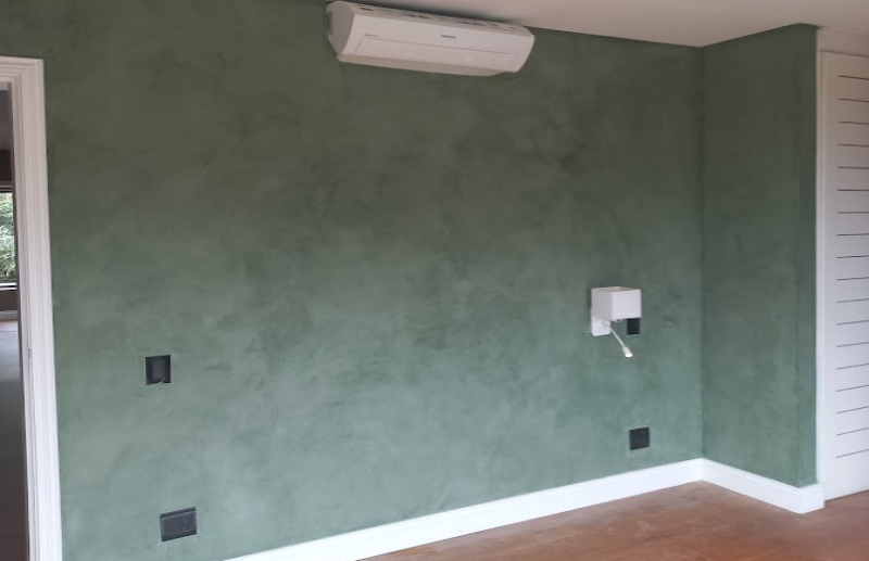 Green micro screed feature wall in residential bedroom