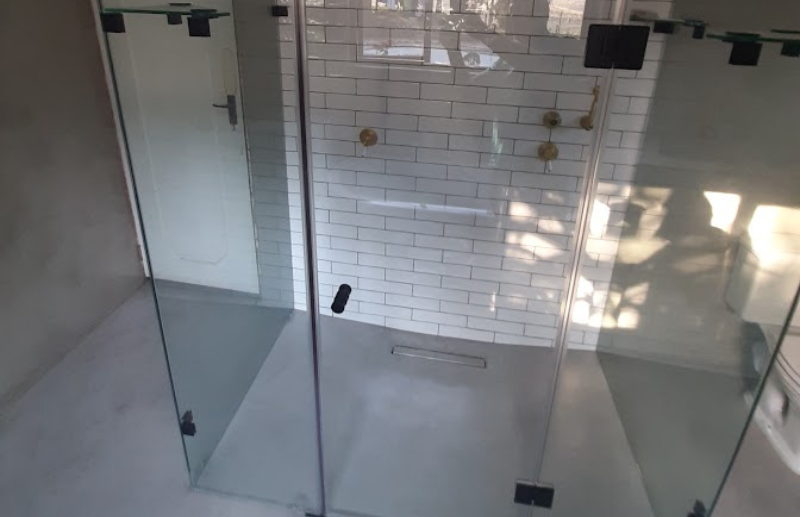 Micro screed shower floor with glass enclosure and subway tiles