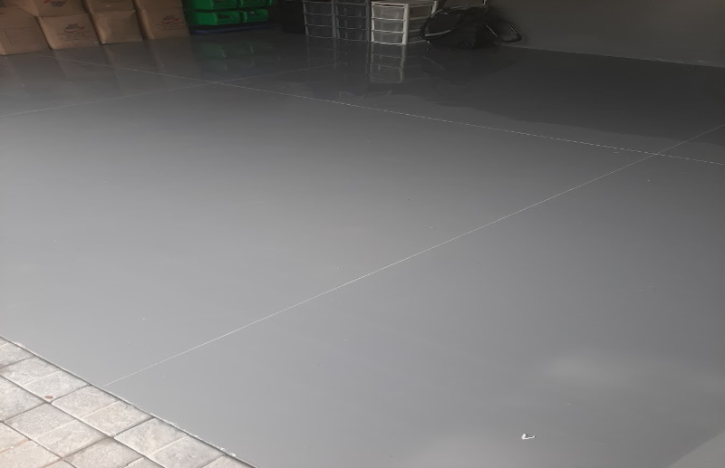 Dark grey epoxy floor coating in residential garage