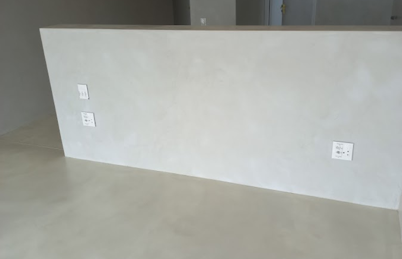 Smooth micro screed wall finish with seamless floor transition